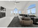 Bright living room featuring cathedral ceilings, large windows with waterfront views and a fireplace at 73 Tidy Island Blvd, Bradenton, FL 34210