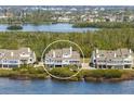 A beautiful waterfront home with a balcony and mature trees at 73 Tidy Island Blvd, Bradenton, FL 34210