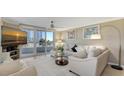 Bright living room featuring a sectional sofa and balcony access at 775 Longboat Club Rd # 304, Longboat Key, FL 34228