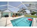 Relaxing pool area with covered patio and colorful furniture at 881 Polaris Rd, Venice, FL 34293