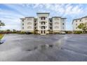 Three-story building with green roof and ample parking at 9203 Griggs Rd # D103, Englewood, FL 34224