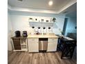 Kitchen with breakfast bar, stainless steel appliances, and farmhouse sink at 970 S Allendale Ave, Sarasota, FL 34237