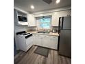 Cozy kitchen featuring white cabinets and modern appliances at 970 S Allendale Ave, Sarasota, FL 34237