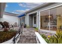 Stone patio with seating area and view into the bright kitchen at 1229 Spoonbill Landings Cir, Bradenton, FL 34209