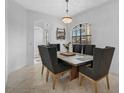 Formal dining room with stylish table, chairs, chandelier, and plenty of natural light at 13408 Swiftwater Way, Bradenton, FL 34211
