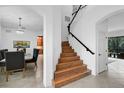 Bright foyer features a wood staircase with iron railing and access to the dining room at 13408 Swiftwater Way, Bradenton, FL 34211