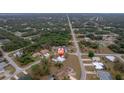 Wider aerial view showing the house and street at 15026 Dania Ave, Port Charlotte, FL 33953