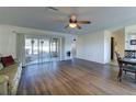 Living room with hardwood floors, sliding doors, and a ceiling fan at 1610 Cypress Point Ct, Venice, FL 34293