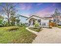 Two story home with a gravel driveway and nicely landscaped yard at 2226 Arlington St, Sarasota, FL 34239