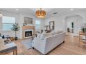 Bright living room featuring a fireplace, light hardwood floors, and ample natural light at 2226 Arlington St, Sarasota, FL 34239