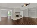 Living room with fireplace and dark brown tile floors at 2534 Stagnaro Rd, North Port, FL 34287