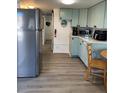 Well-equipped kitchen featuring light teal cabinets and stainless steel appliances at 2601 Gulf N Dr # 729, Bradenton Beach, FL 34217