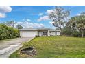 Well maintained exterior elevation featuring a manicured lawn and an attached two car garage at 3151 Johannesberg Rd, North Port, FL 34288