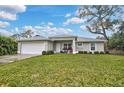 Well maintained exterior elevation featuring a manicured lawn and an attached two car garage at 3151 Johannesberg Rd, North Port, FL 34288