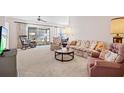 Living room with floral sofa, rocking chairs and TV at 3701 39Th W St, Bradenton, FL 34205