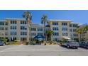 Condo building exterior showcasing its architecture and parking at 3810 Gulf Of Mexico Dr # F302, Longboat Key, FL 34228