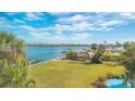 Scenic waterfront view with lush lawn, gazebo, and dock at 3810 Gulf Of Mexico Dr # F302, Longboat Key, FL 34228