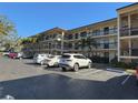 Two story condo building with parking lot and landscaping at 425 30Th W Ave # C212, Bradenton, FL 34205