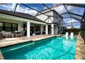 Inviting pool area with a screened enclosure, patio furniture, and a spacious deck at 4304 Fly Rod Ter, Parrish, FL 34219