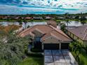 Stunning property overlooking a lake with a large backyard and two-car garage at 4917 Sabal Lake Cir, Sarasota, FL 34238