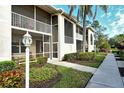 Condo building exterior with screened patio and walkway at 5250 Hyland Hills Ave # 1515, Sarasota, FL 34241