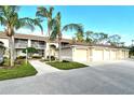 Condo building exterior with attached garages and landscaping at 5250 Hyland Hills Ave # 1515, Sarasota, FL 34241