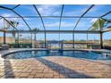 Relaxing pool and spa with a waterfall feature and screened enclosure at 5607 Tidewater Preserve Blvd, Bradenton, FL 34208