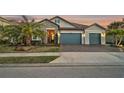 Beautiful two-story house with stone accents and a three-car garage at 6625 Dovekey Dr, Sarasota, FL 34241