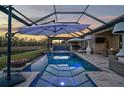 Stunning pool with spa, fire pit, and covered lanai at 6625 Dovekey Dr, Sarasota, FL 34241