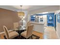 Bright dining area with glass table and kitchen access at 7340 Silver Fern Blvd # 5, Sarasota, FL 34241