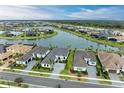 Aerial view of a lakefront community with many homes at 9048 Bernini Pl, Sarasota, FL 34240