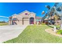 Two-story house with three-car garage and landscaped yard at 11306 77Th E St, Parrish, FL 34219