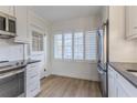 Bright kitchen with white cabinets, stainless steel appliances, and dark countertops at 116 23Rd W St, Bradenton, FL 34205