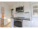 White kitchen with stainless steel appliances and shaker cabinets at 116 23Rd W St, Bradenton, FL 34205