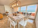 Elegant dining area with glass table and ocean views at 1906 Gulf N Dr # 106, Bradenton Beach, FL 34217