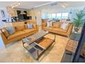 Open concept living area with modern coffee table and leather sofas at 1906 Gulf N Dr # 106, Bradenton Beach, FL 34217