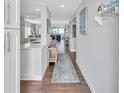 Bright entryway with hardwood floors and view to living room at 20 Whispering Sands Dr # 306, Sarasota, FL 34242
