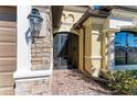 Front entry with paver walkway and screened door at 20710 Saluti Pl, Venice, FL 34293
