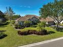 Single story house with a well-maintained lawn and landscaping at 2173 Muskogee Trl, Nokomis, FL 34275