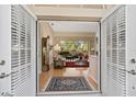 View from entryway into living room with hardwood floors at 2173 Muskogee Trl, Nokomis, FL 34275