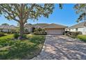 House exterior showcasing a driveway and landscaping at 2173 Muskogee Trl, Nokomis, FL 34275