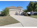 Tan house with a two-car garage and landscaped yard at 2824 47Th E St, Palmetto, FL 34221
