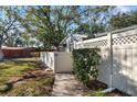 Landscaped side yard with a gate and fence at 2925 29Th W Ave, Bradenton, FL 34205
