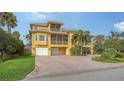 Beautiful yellow house with a two car garage and palm trees at 343 S Orchid Dr, Ellenton, FL 34222