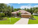 Single-story house with tile roof and lush green landscaping at 3861 Royal Hammock Blvd, Sarasota, FL 34240