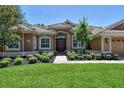 Home exterior with double doors and manicured landscaping at 3861 Royal Hammock Blvd, Sarasota, FL 34240