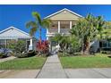 Two-story house with front porch, landscaping, and walkway at 4755 Woodbrook Dr, Sarasota, FL 34243