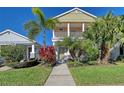 Two-story house with front porch, landscaping, and walkway at 4755 Woodbrook Dr, Sarasota, FL 34243