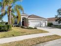 Single-story home with three car garage and lush landscaping at 4831 Boston Common Gln, Bradenton, FL 34211