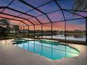 Enclosed pool and spa area with lake views at sunset at 4831 Boston Common Gln, Bradenton, FL 34211